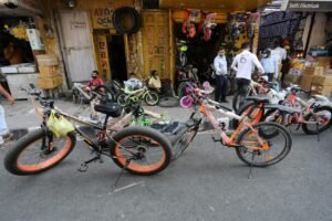 Indian people look at bicycles displayed for sale outside a shop in Jammu, India, 16 October 2020. According to All India Bicycle Manufacturers Association (AICMA), sales of bicycles in India almost doubled over the past five months as more people tend to use bicycles as a low-cost mean of transport amid health concerns over the coronavirus covid-19 pandemic. EPA-EFE/,Image: 563602560, License: Rights-managed, Restrictions: , Model Release: no